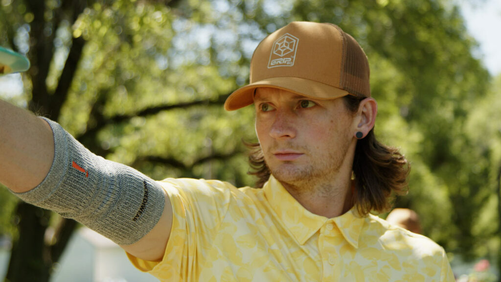 A headshot of Ben Callaway with him looking off the left side of the frame. He's wearing a tan GRIPeq trucker hat.