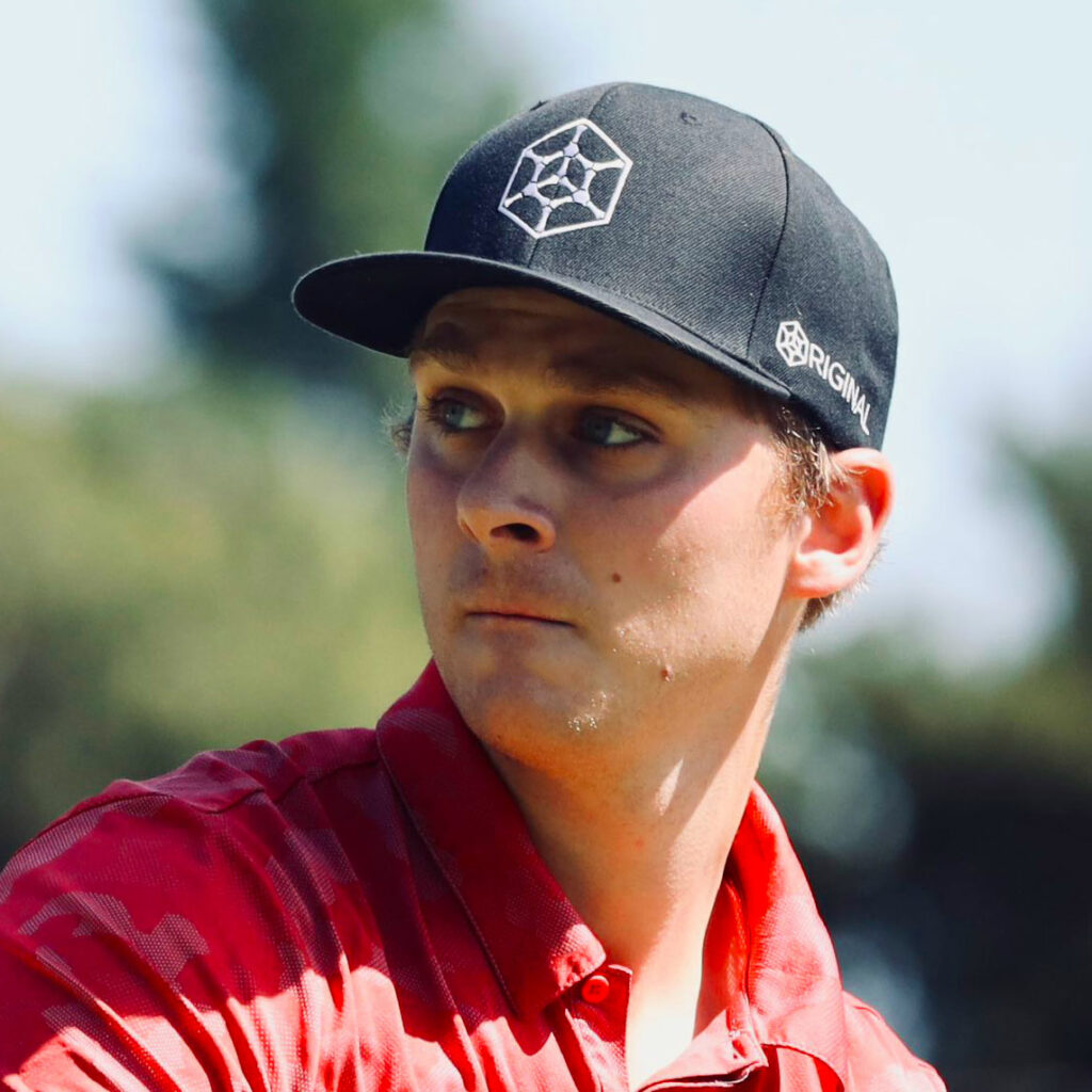 Team GRIPeq member Adam Hammes wearing a GRIPeq flat bill hat and looking off towards the left side of the frame.