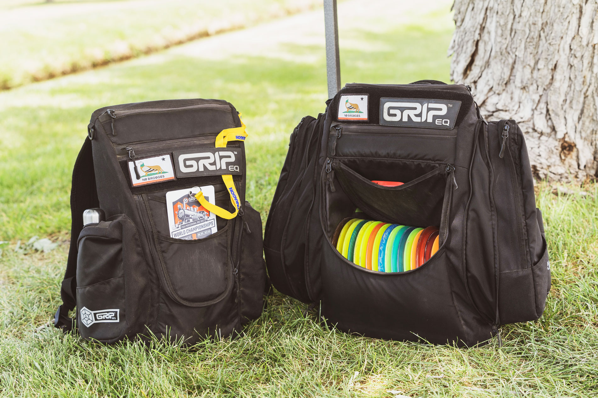 Two black GRIPeq bags, a CS2 and an AX5, site on the grass.