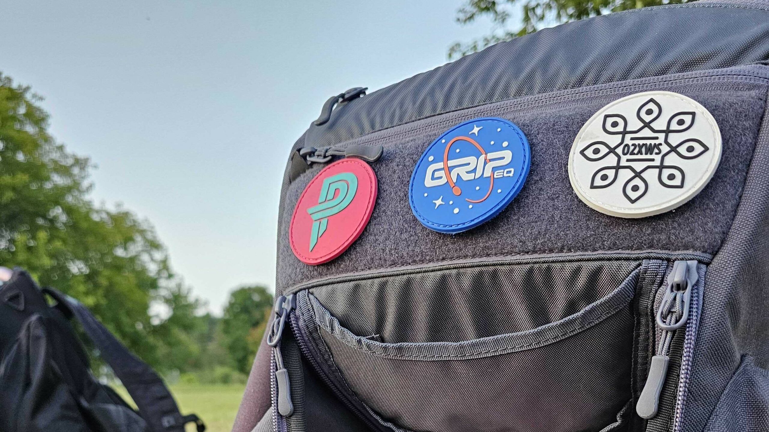 Gray GRIPeq bag featuring a Paige Pierce, Ohn Scoggins, and GRIPeq orbit patch.