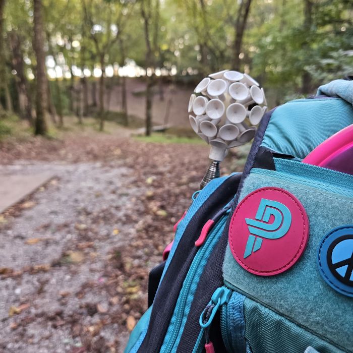 GRIPeq BX3 Paige Pierce bag with a disc retriever held on the side synch strap.