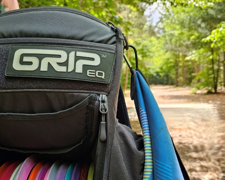 GRIPeq Gray CS2 bag with a fairway in the background and a GRIPeq GOAT Towel attached to the D-Ring on the bag.
