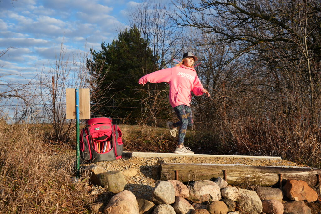 Team GRIPeq member Genevieve Davis throwing a disc.