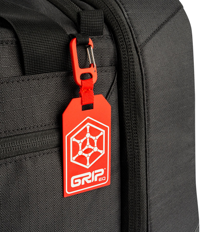A red, aluminum bag tag with the GRIPeq logo on it.