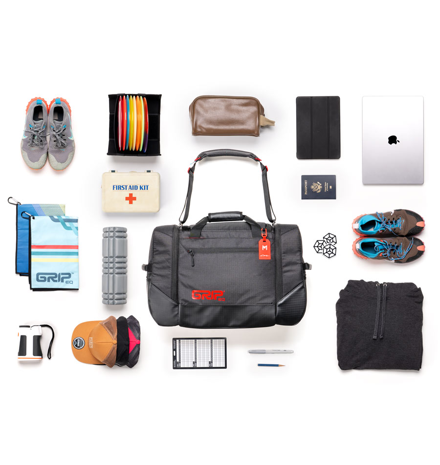 A view of the MB-TSD1 bag surrounded by all of the things that could potentially fit inside like shoes, discs, waterbottles, towels, hats, etc.
