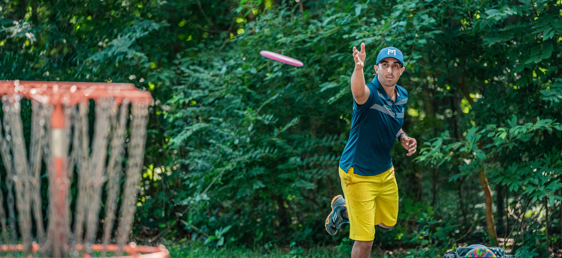 Paul McBeth throws a putt into a disc golf basket.