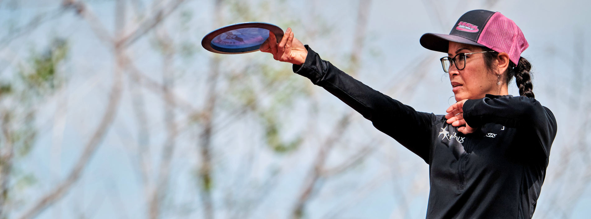 Team GRIPeq member, Ohn Scoggins lining up a disc golf shot.