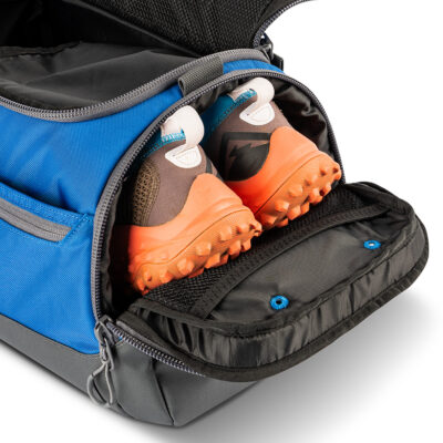 Blue disc golf duffel opened with shoes