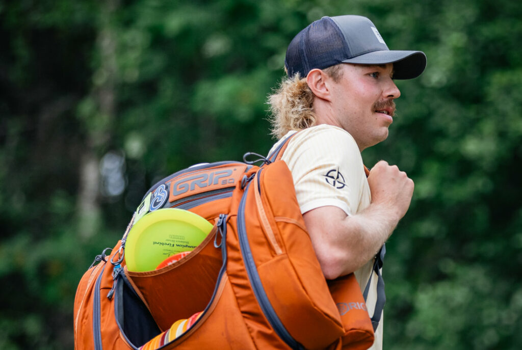 Team GRIPeq member, Väinö Mäkelä, with an orange GRIPeq AX6 slung over one shoulder.